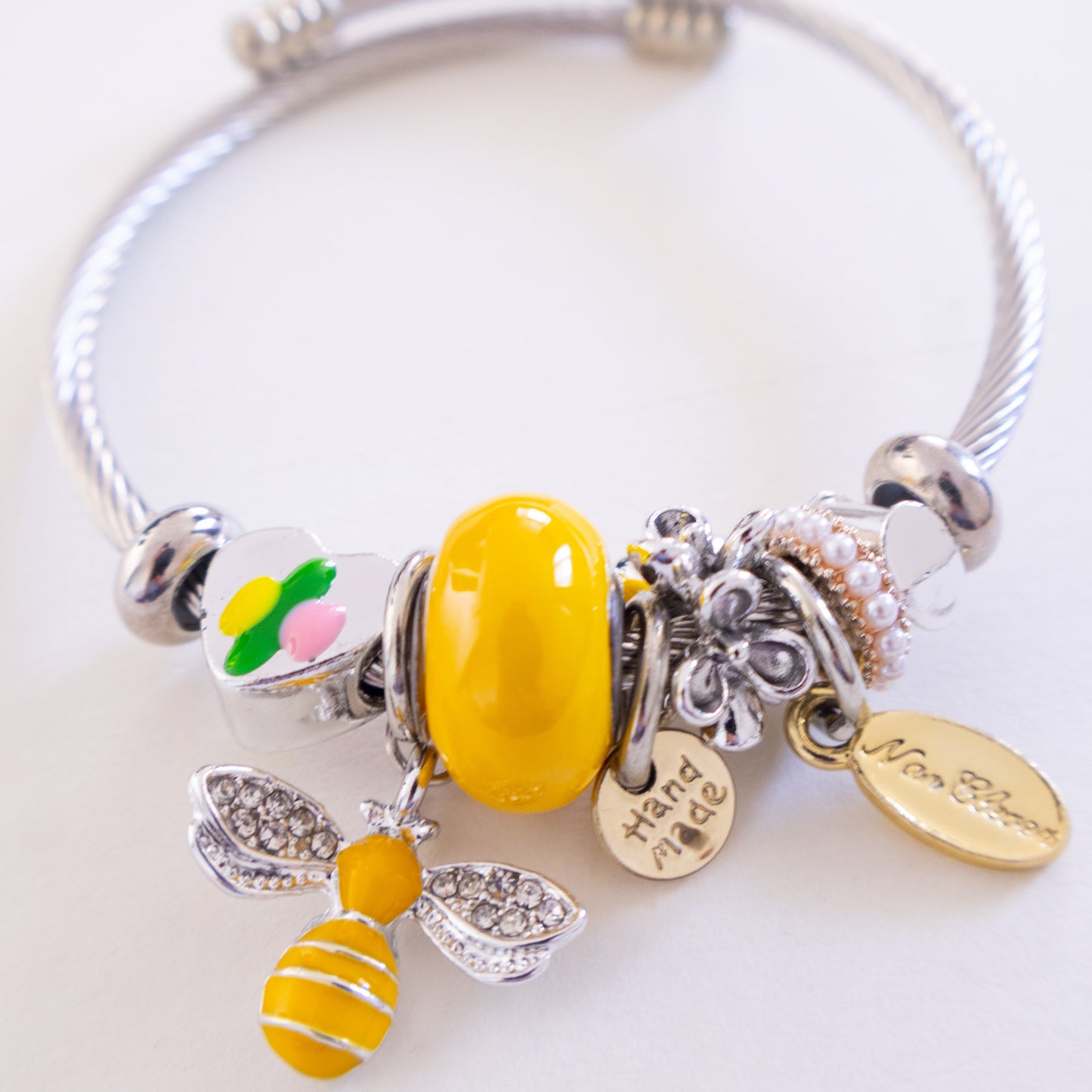 Silver bracelet with colorful beads on a white background