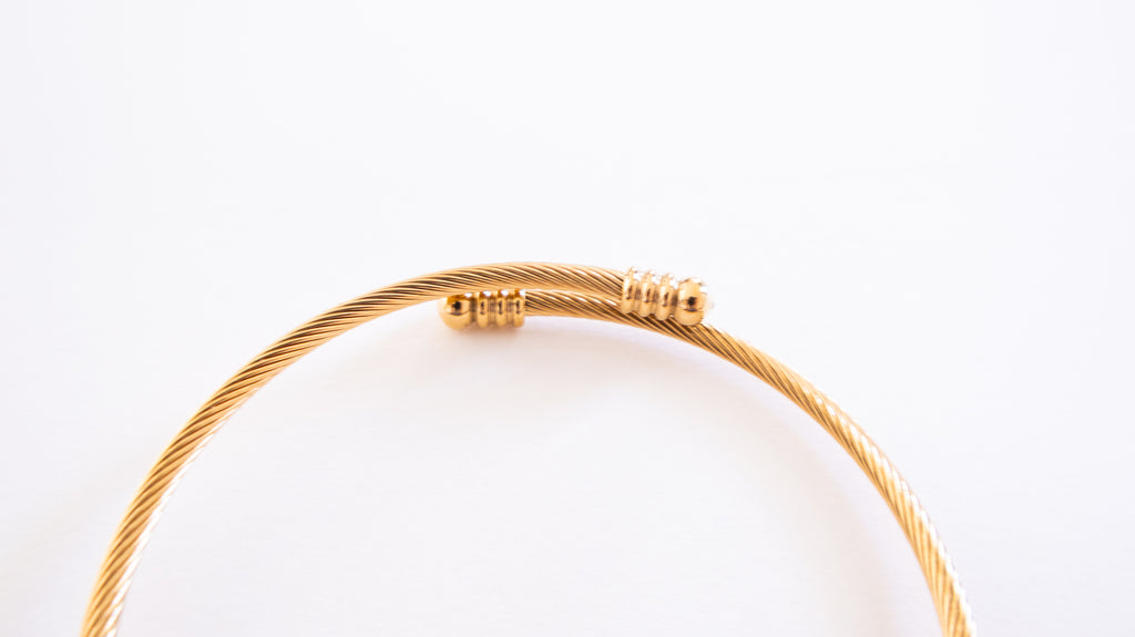 Gold bracelet on a white background