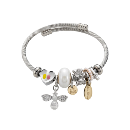 Silver bracelet with various charms on a white background