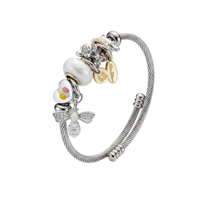 Silver bracelet with various charms on a white background