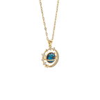 Gold necklace with a blue gemstone pendant on a white background