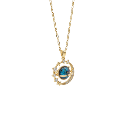 Gold necklace with a blue gemstone pendant on a white background