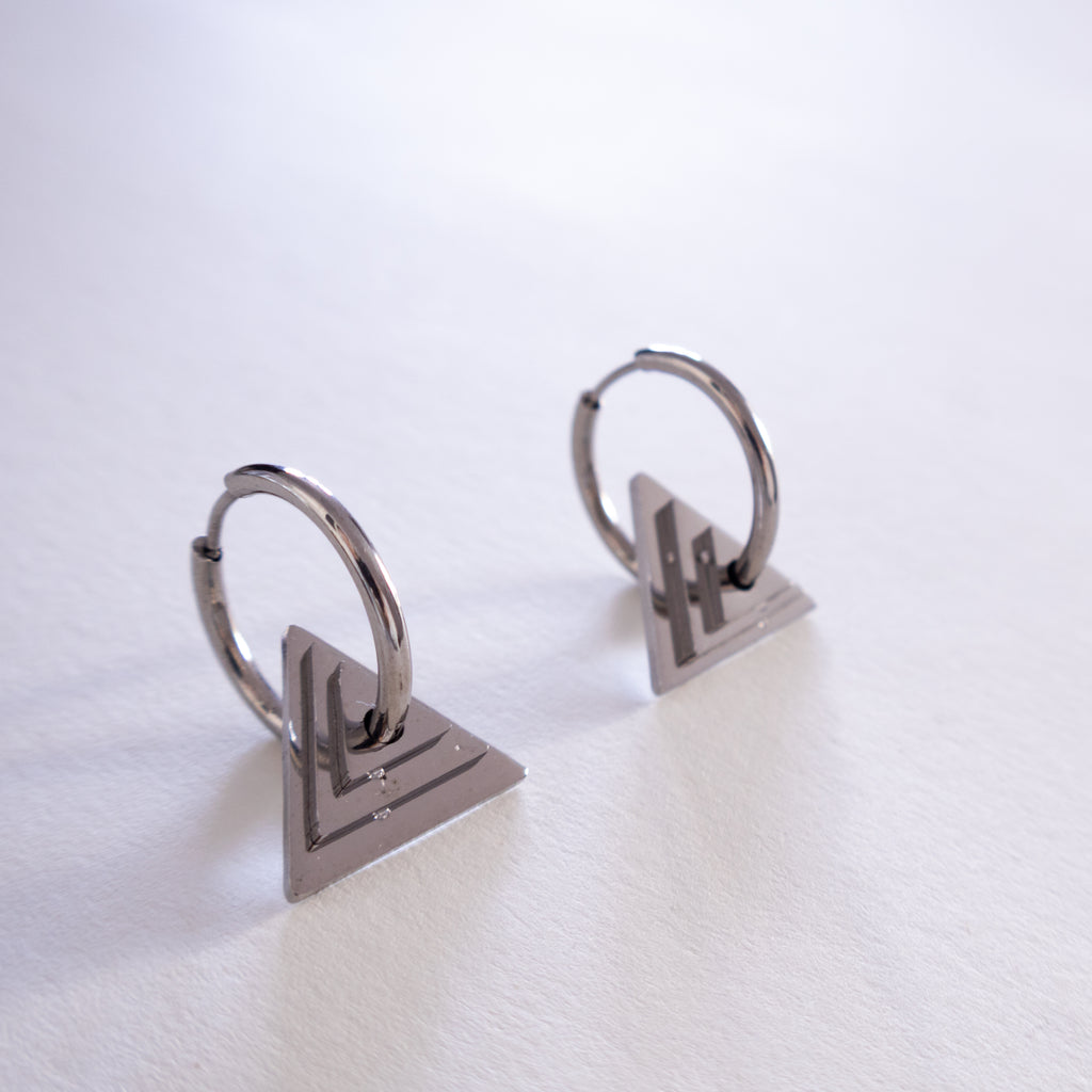Pair of silver hoop earrings on a white background