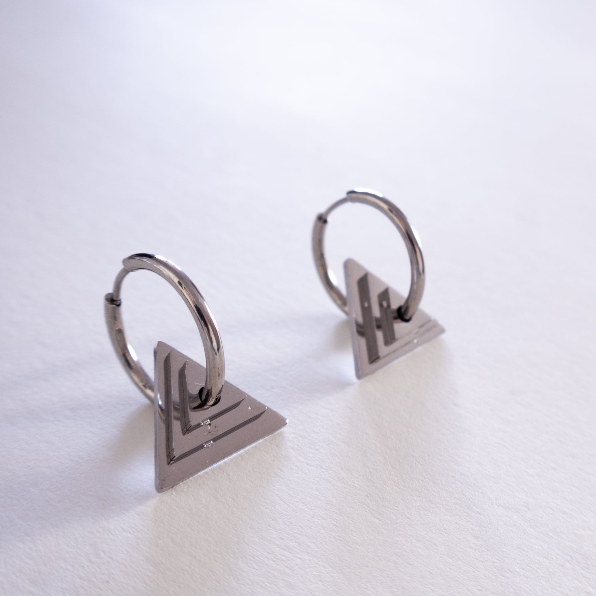 Pair of silver hoop earrings on a white background