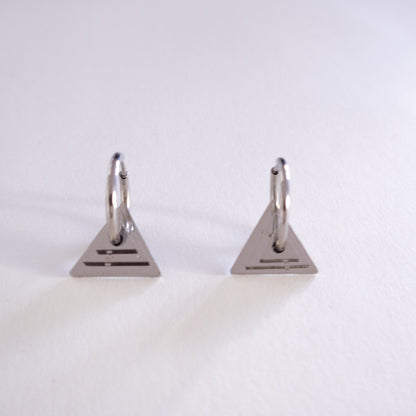 Pair of silver triangle-shaped earrings on a white background