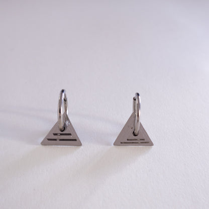 Pair of triangle-shaped earrings on a light gray background
