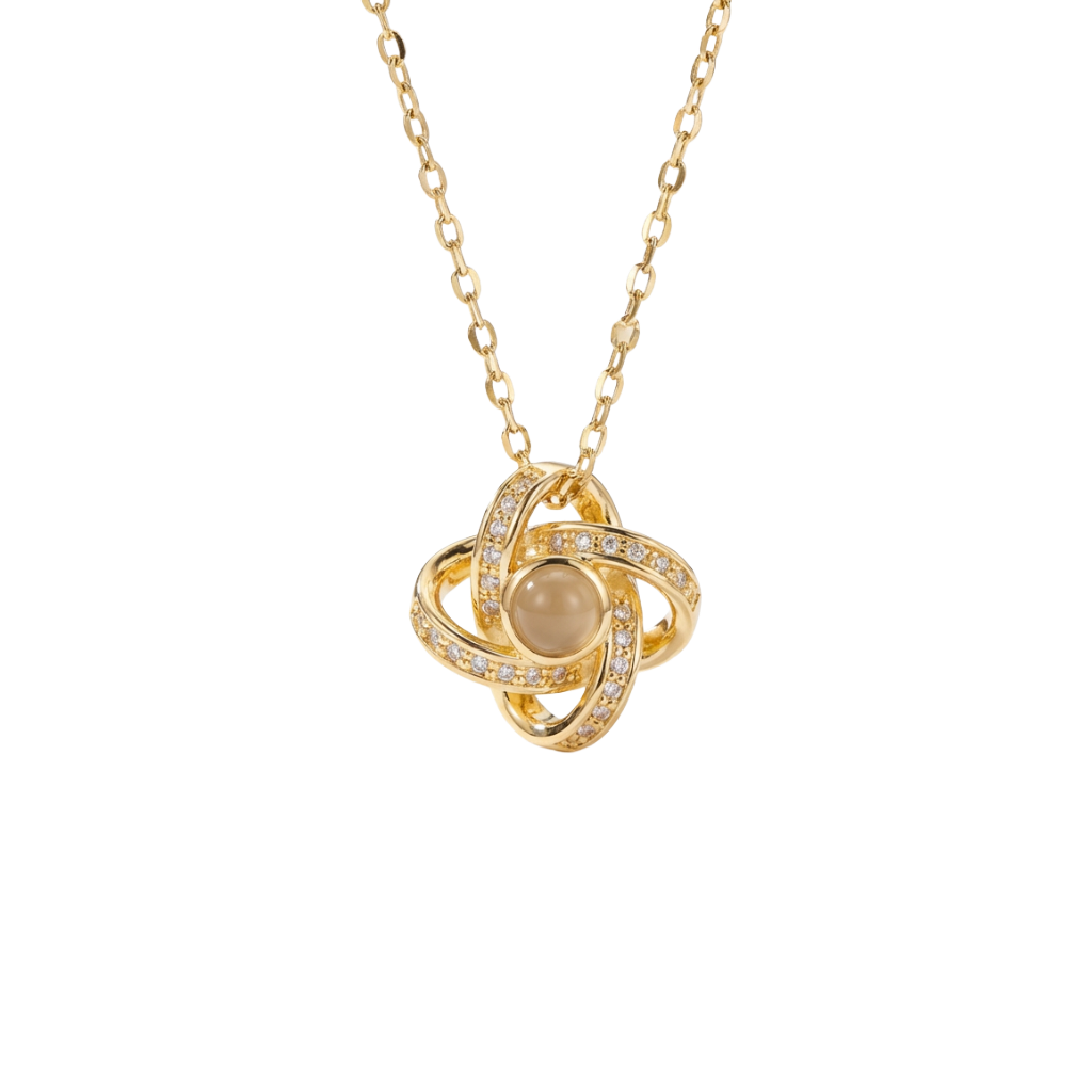 Gold necklace with a circular pendant on a white background