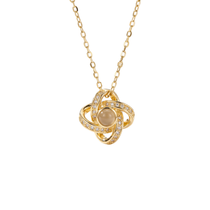 Gold necklace with a circular pendant on a white background