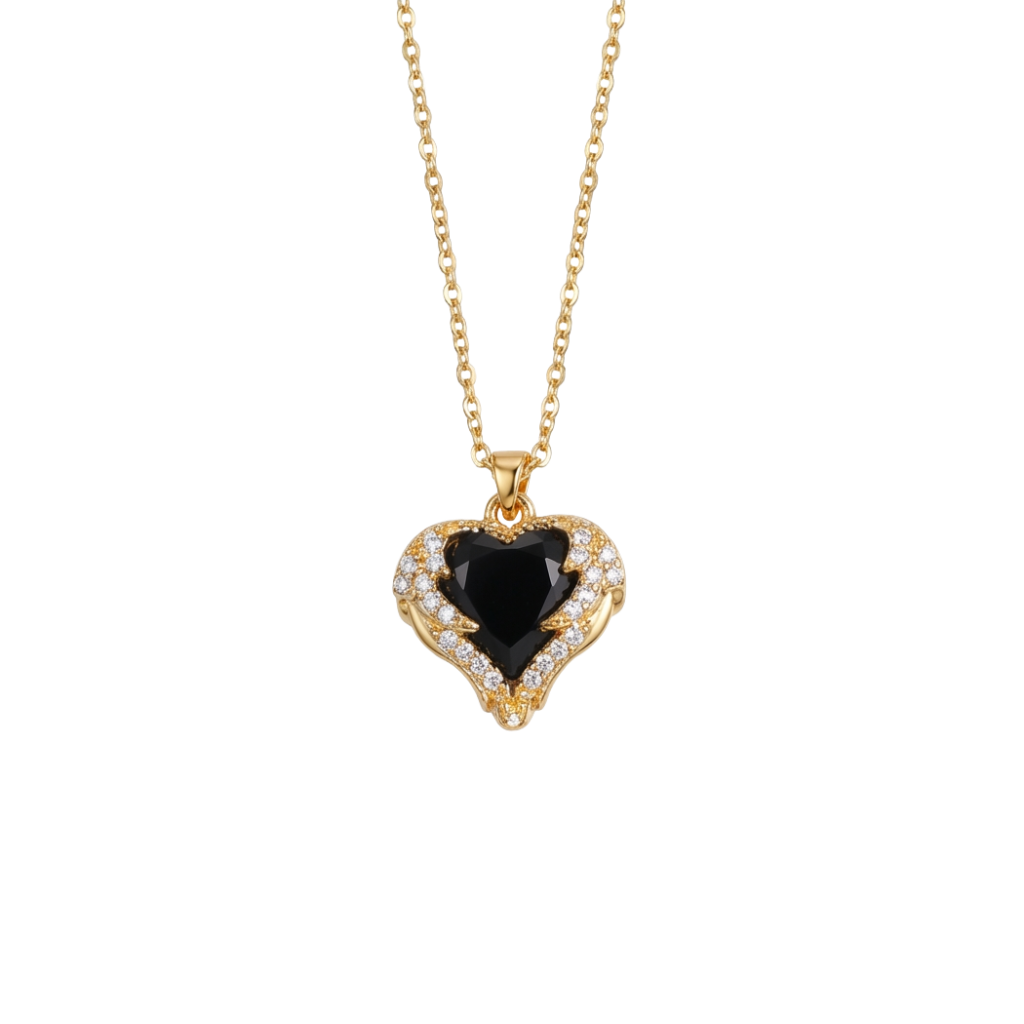 Gold necklace with a heart-shaped black gemstone pendant on a white background