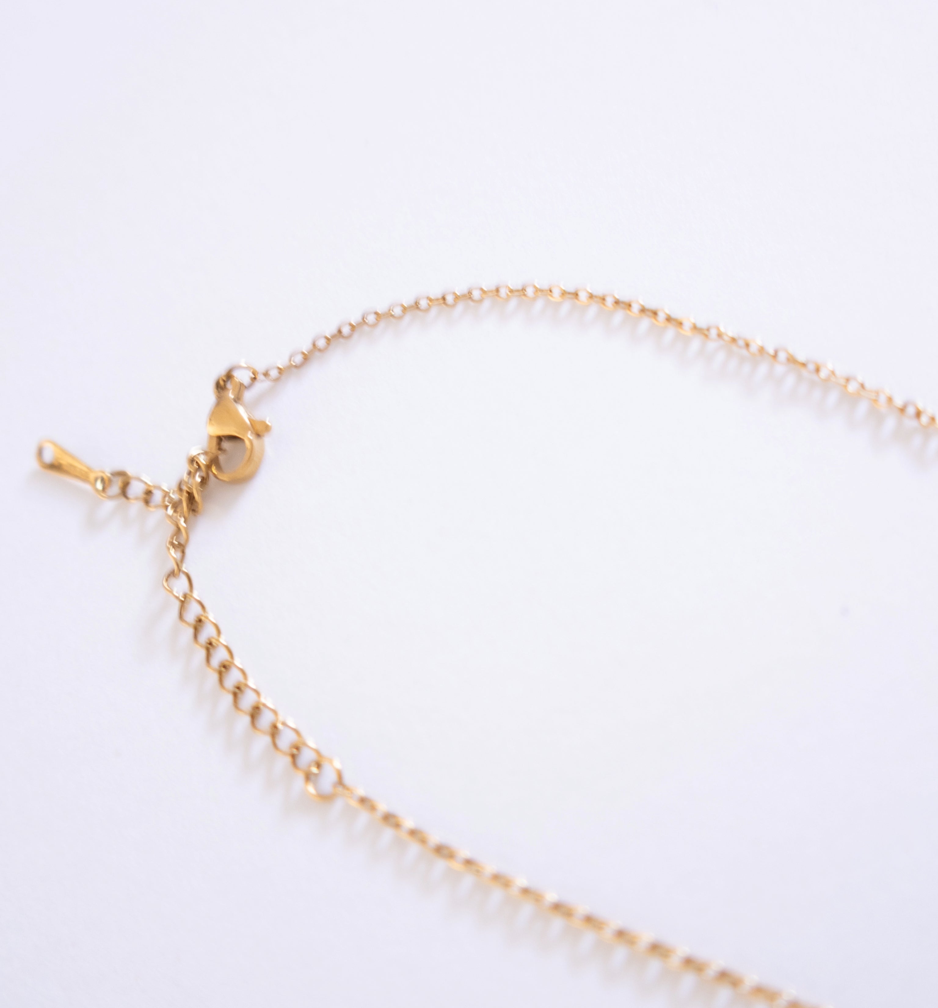 Gold bracelet on a white background