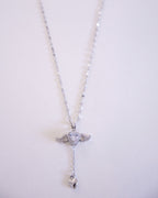 Silver necklace with a heart pendant on a light gray background