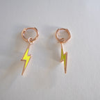 Pair of lightning bolt earrings on a light gray background